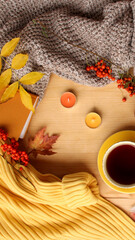 cup of hot tea or coffee, autumn flat in hugg style, with yellow leaves, cozy knitwear, candles and berries, blank for designer, invitation, congratulations, calendar, mock up, copy space