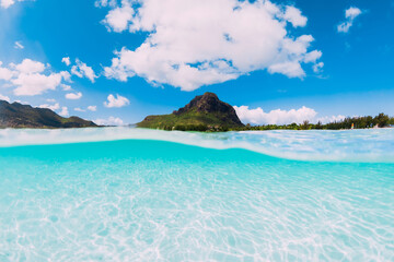 Tropical ocean with sand and Le Morne mountain in Mauritius.