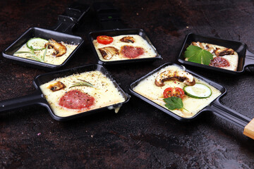 Delicious traditional Swiss melted raclette cheese on diced boiled or baked potato.