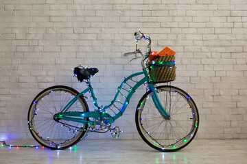 Christmas bicycle ready for delivering presents over bricks wall