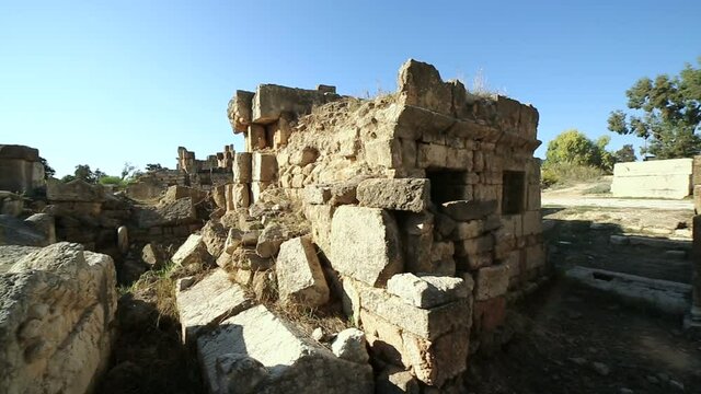 Pan left on old Roman graves and ruins at Tyre, Lebanon