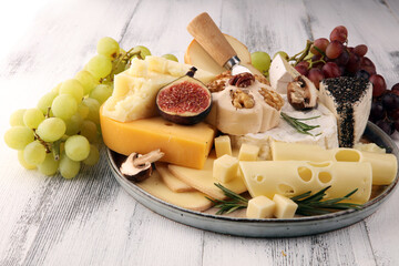 Different sorts of cheese. Cheese platter with different cheese and spice
