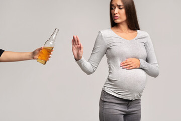 Pregnant Lady Gesturing No To Beer Bottle, Studio Shot