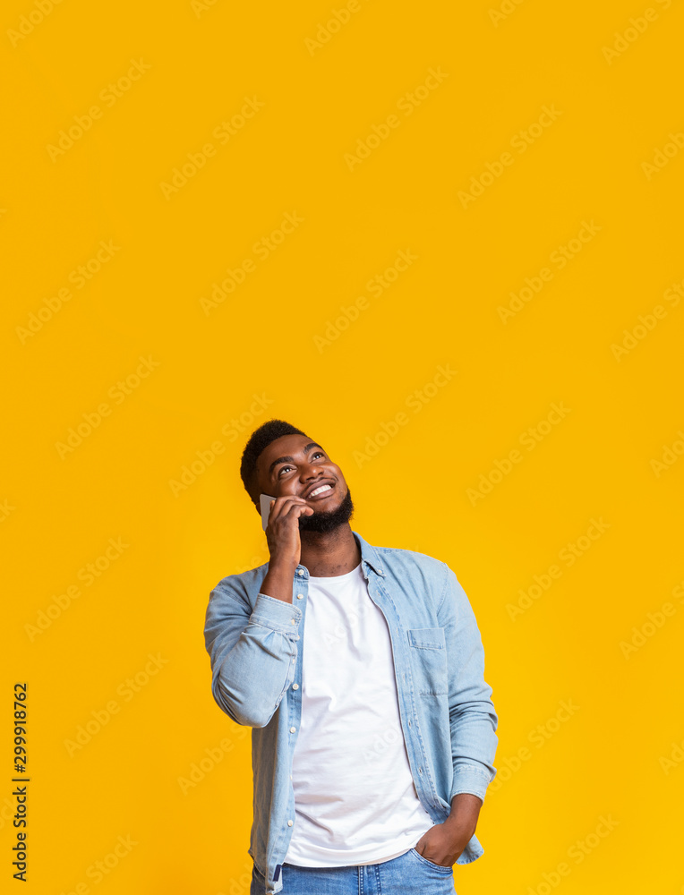 Aufkleber man talking on phone and looking upwards at copy space