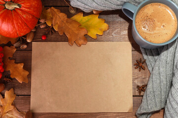 Grey cup of coffee with milk and spices, scarf, yellow oak leaves, acorns, orange pumpkins on dark brown wooden table. Welcome Autumn concept. Fall, spicy latte, thanksgiving, top, copy space