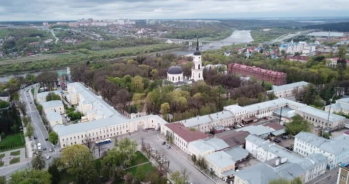 Aerial view of Orthodox Holy Trinity Cathedral on background with modern cityscape of Russian town of Kaluga in cloudy spring day