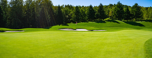 Panorama View of Golf Course with beautiful putting green. Golf course with a rich green turf...