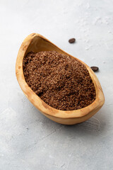 Spa and relax. Coffee scrub in olive plate top view