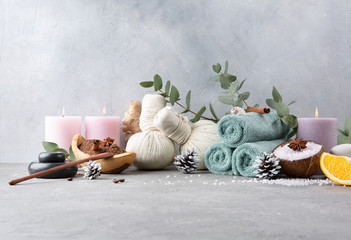 Beautiful winter spa relax concept. Coffee with cinnamon scrub, cotton pouches with herbs for...