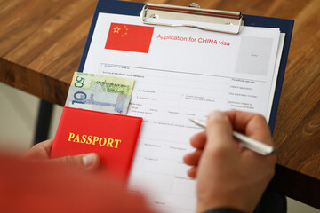 Male hand hold silver pen with passport