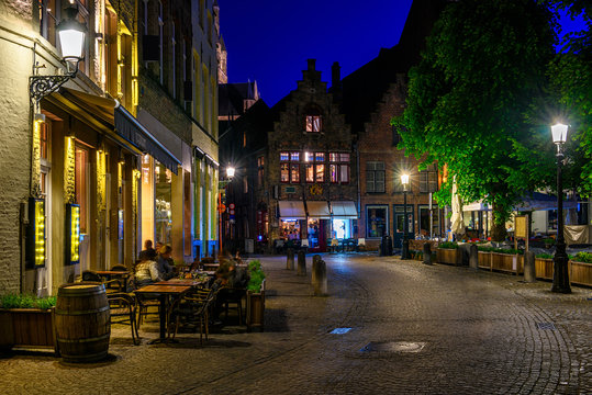 Old street in Bruges (Brugge), Belgium. Night cityscape of Bruges. Typical architecture of Bruges