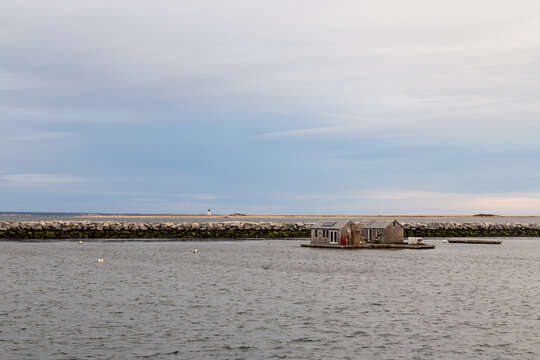 Boathouse and the Long Point Light Station in the distance panoramic view from MacMillan Wharf.