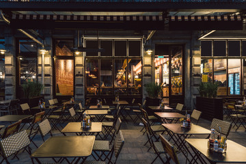 Old street with tables of cafe in center of Brussels, Belgium. Night cityscape of Brussels (Bruxelles). Architecture and landmarks of Brussels.