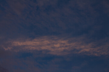 Beautiful and romantic clouds of warm colors during sunset. Sunset as background. Resource for designers.