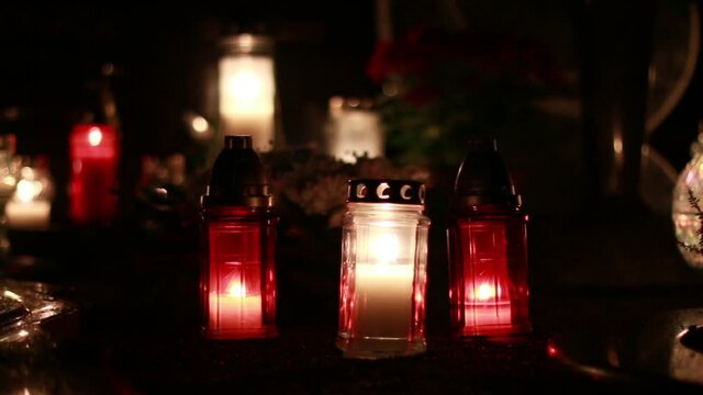 Close-Up Of Candles Burning At A Cemetery During All Saints Day.