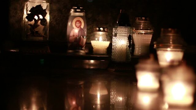 Close-Up Of Candles Burning At A Cemetery During All Saints Day.