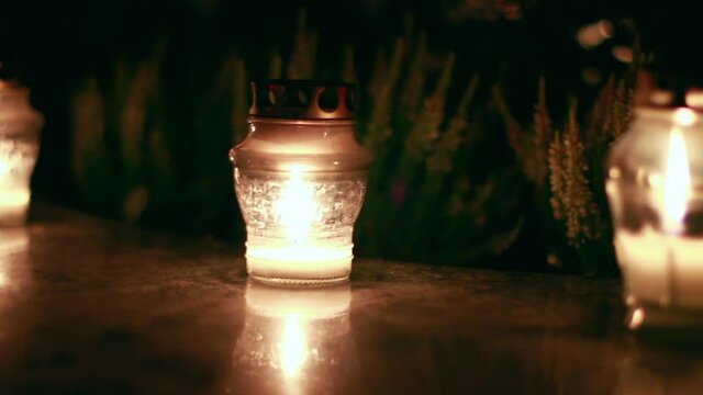 Close-Up Of Candles Burning At A Cemetery During All Saints Day.