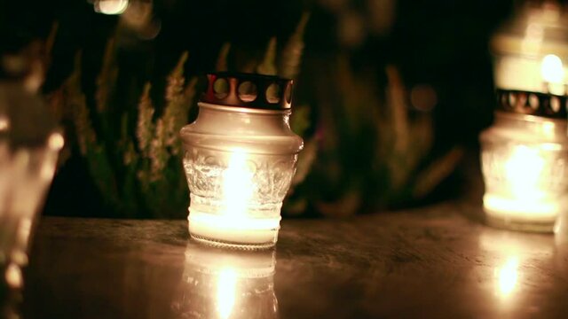 Close-Up Of Candles Burning At A Cemetery During All Saints Day.