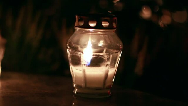 Close-Up Of Candles Burning At A Cemetery During All Saints Day.