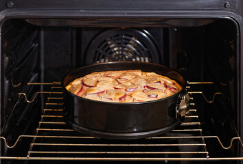 Freshly made homemade apple pie in the domestic oven. Shallow focus.