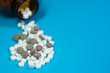 pills and bottle on blue background