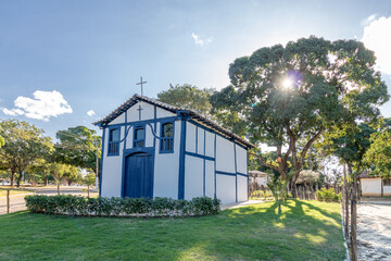 white and blue small colonial chapel and green grass