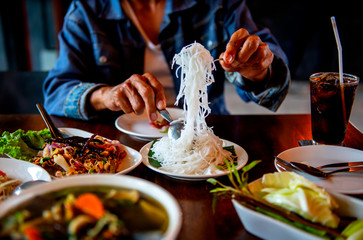 Young men who are happy to eat many foods on the table