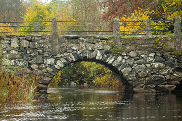 Old stone bridge on autumn colors - 299931123