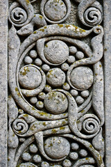 Intricately carved gravestone with celtic design circles and swirls
