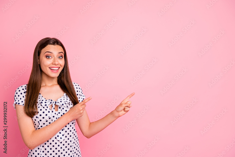 Wall mural photo of attractive cute nice girl showing two forefingers at once at something that is definitely w