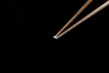 chopsticks picking up a grain of rice