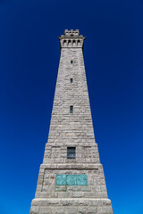 Pilgrim Monument Tower against blue sky background, Provincetown, Cape Cod, MA 