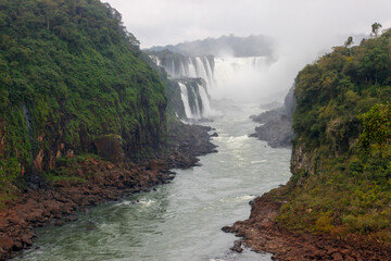 The main attraction of Brazil and Argentina is the famous Iguazu Falls among the lush green jungle. Huge streams of water fall to the ground. UNESCO World Heritage. Picture from paradise.