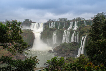 The main attraction of Brazil and Argentina is the famous Iguazu Falls among the lush green jungle. Huge streams of water fall to the ground. UNESCO World Heritage. Picture from paradise.