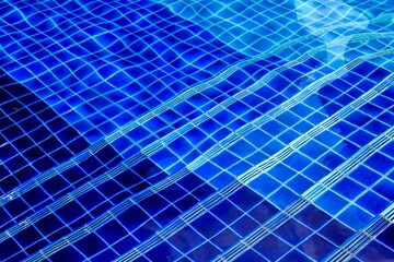 Stair steps into under water in outdoor swimming pool.