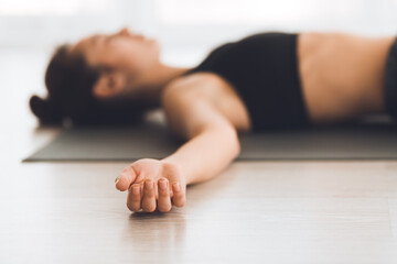 Young woman practicing yoga in corps pose