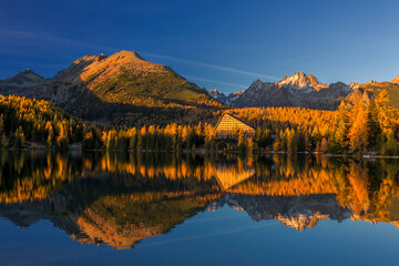 Obraz premium Autumn in Strbske lake in Slovakia during golden hour Tatra Mountains on the bakcground