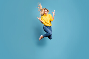Full body photo of crazy lady jumping high enjoy metal rock concert showing hands horns excited...