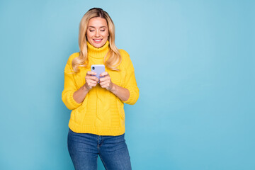 Photo of amazing blond lady holding telephone hands texting comments feednews wear knitted yellow pullover jeans isolated blue color background