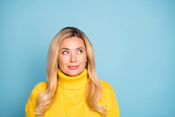 Closeup photo of amazing pretty blond lady looking wondered empty space have crazy idea wear warm knitted yellow jumper isolated blue color background