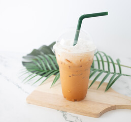 Thai tea in plastic glass on white background, Iced milk tea or Thai milk tea on white background