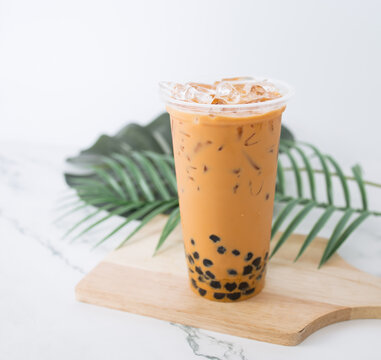 Taiwan milk tea with bubble plastic glass on wood background