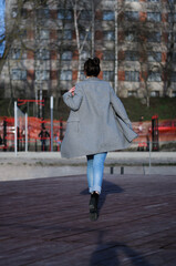 Full body portrait. Young brunette woman in blue jeans 