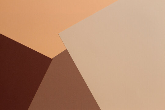 Color papers geometry composition background with beige, light brown and dark brown tones.