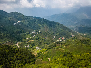 Naklejka na ściany i meble Aerial View of Beautiful Green Scenic Valley with Settlements near Alishan Scenic Area in Taiwan