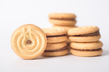 Cookies stuffed with coffee cream stacked on a white background.