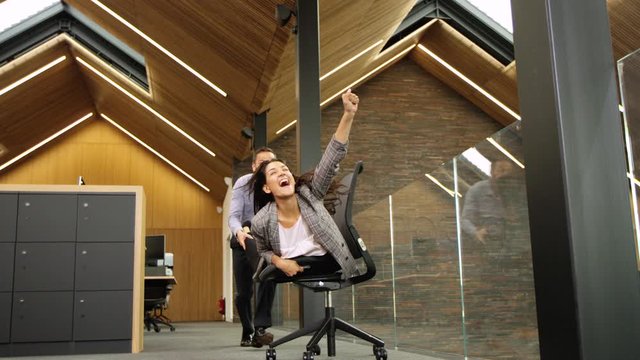 Bullet time, Business colleagues having way too much fun during their break in a large modern corporate office.