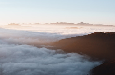 Perfect morning moment in alpine foggy valley.
