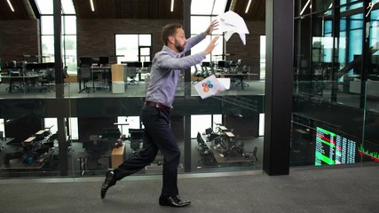 Bullet time shot of businessman with stack of papers tripping in the workplace