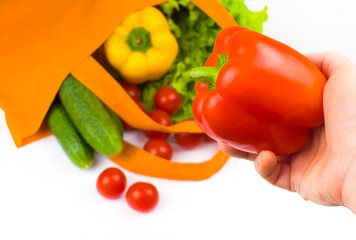 Eco shopping bag with healthy vegetables on a light background.